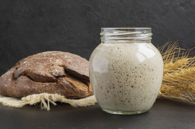 Active rye sourdough in a glass jar for homemade bread.